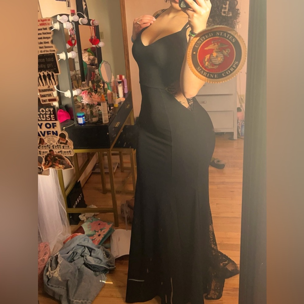 Long black prom dress with a laced train, lace on the sides, and great shape